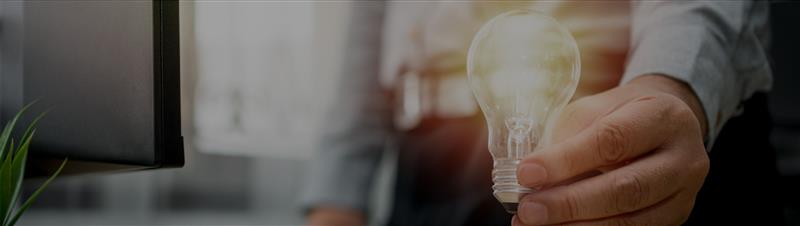 Man Holding Lightbulb in Hand