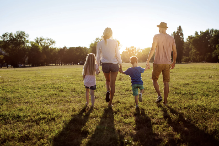 Family walking at sunset