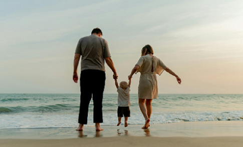 Family Walking on Beach at Sunset