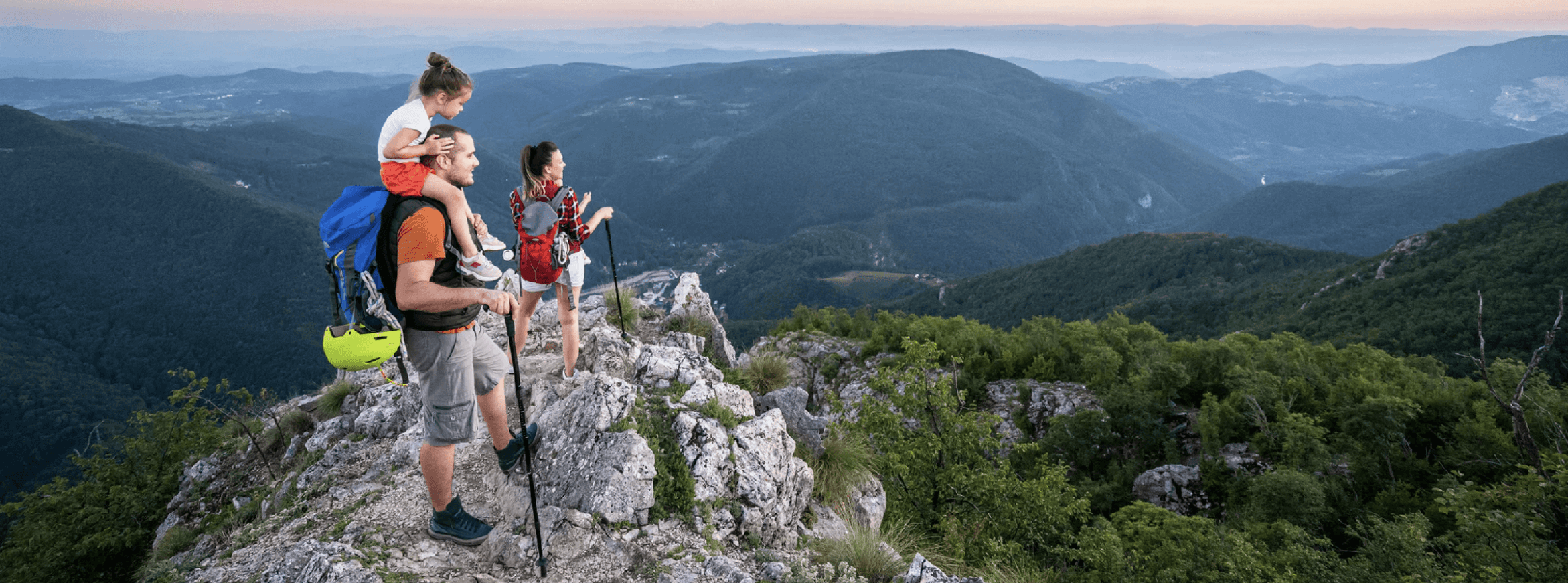Family hiking with a landscape in the background